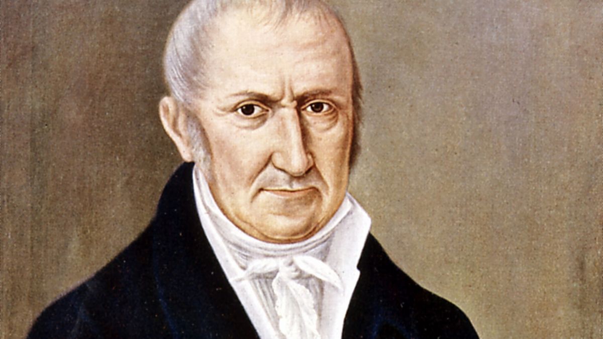 Porträt eines Mannes mit ernstem Gesichtsausdruck und klassischer Kleidung.