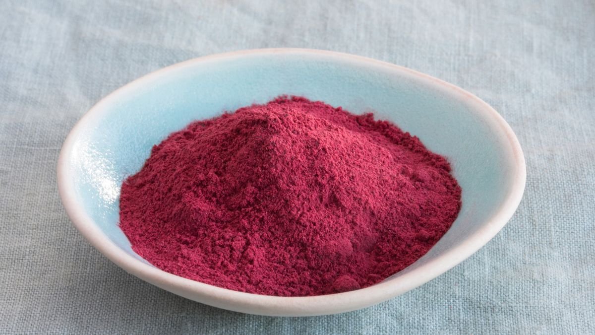 Eine Schale mit feinem, rotem Hahnenpulver auf einem Tisch.