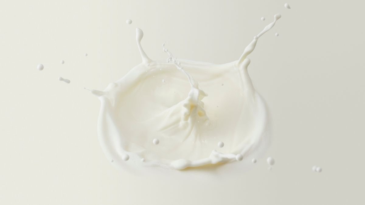 Ein Spritzer Ziegenmilch, der auf einer hellen Oberfläche landet.