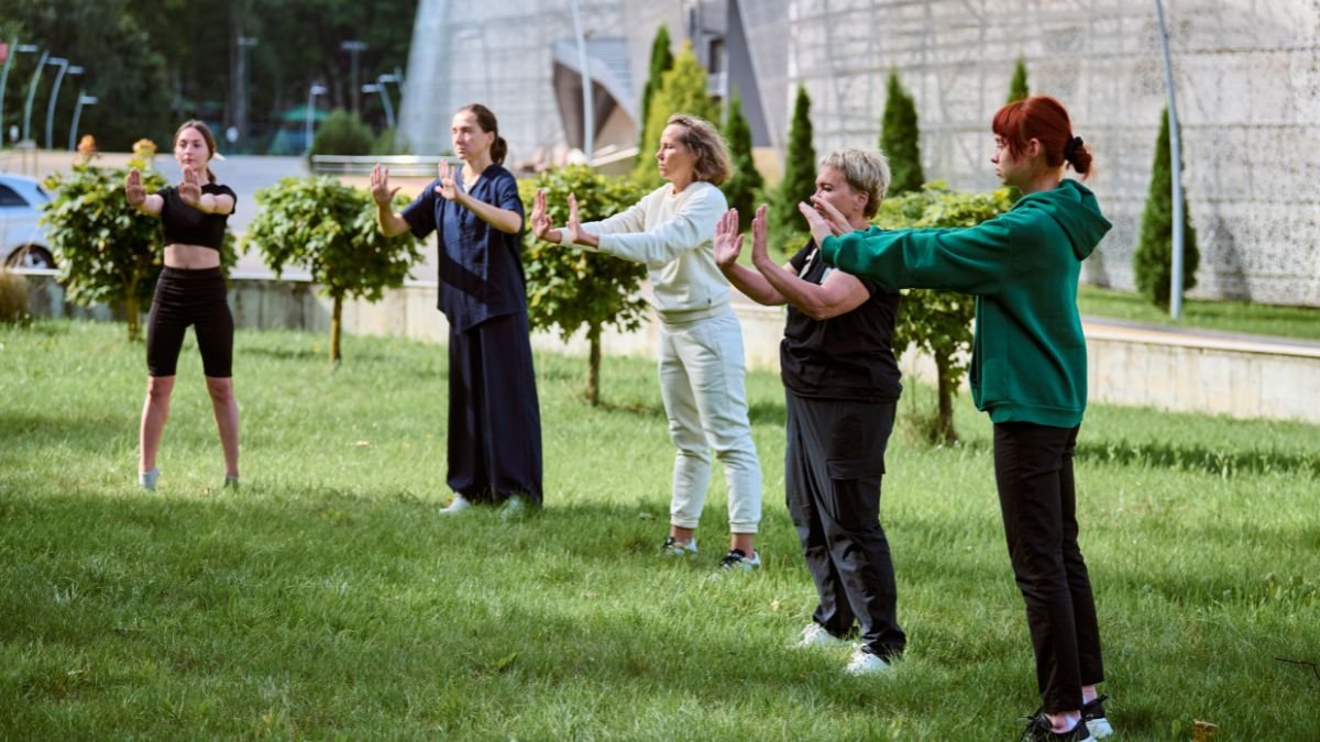 Fünf Personen praktizieren Chi Kung im Freien, um Körper und Geist in Einklang zu bringen.