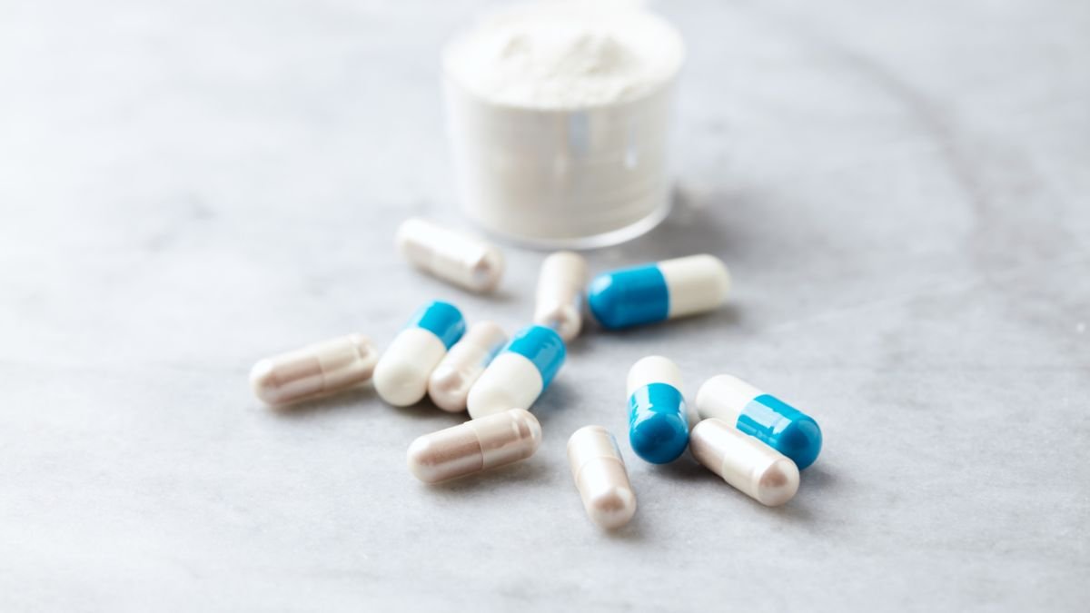 Eine Auswahl von L-Carnitin-Kapseln und Pulver auf einem Tisch.